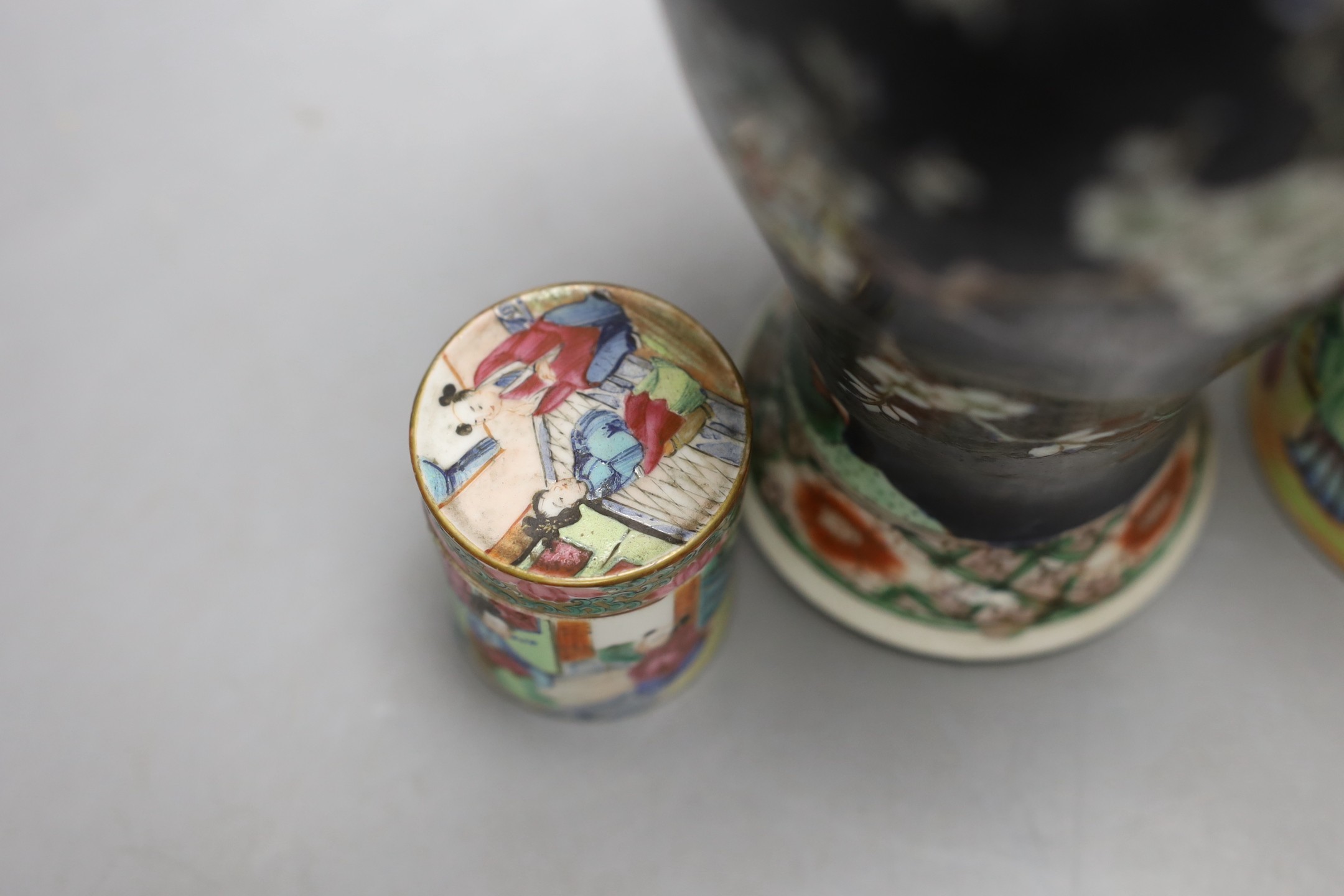 A Chinese famille noire vase, and two famille rose lidded pots, 19th century, Vase 12 cms high.